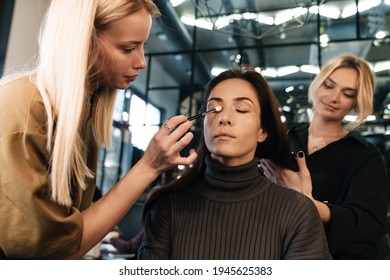 Young Two Women Doing Hairstyle And Makeup For Their Client In Beauty Salon