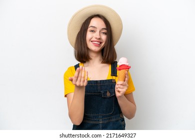 Young Ukrainian woman with a cornet ice cream isolated on white background inviting to come with hand. Happy that you came