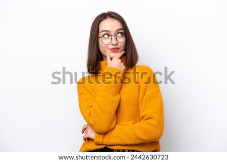 Young Ukrainian woman isolated on white background thinking an idea while looking up