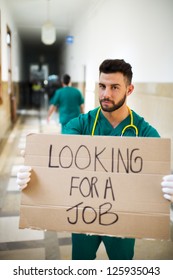 Young Unemployed Doctor Holding A Sign