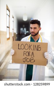 Young Unemployed Doctor Holding A Sign