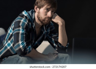 Young Unemployed Man Sitting On The Sofa