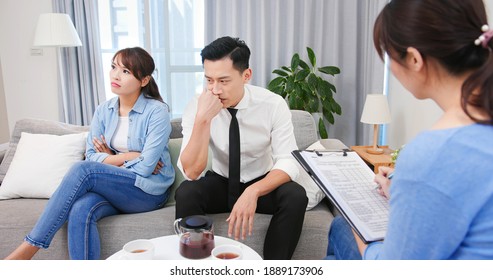 Young unhappy asian couple having marriage counseling