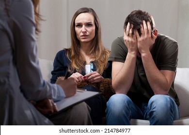 Young Unhappy Couple At Odds On Therapy Visit 