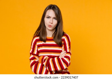 Young unhappy dissatisfied offended sad caucasian woman in red striped sweatshirt hold hands crossed folded look camera isolated on plain yellow background studio portrait. People lifestyle concept - Shutterstock ID 2239017407