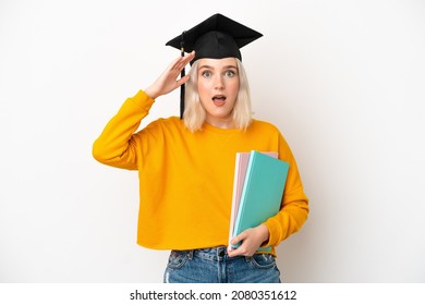 Young university caucasian woman graduate isolated on white background with surprise expression