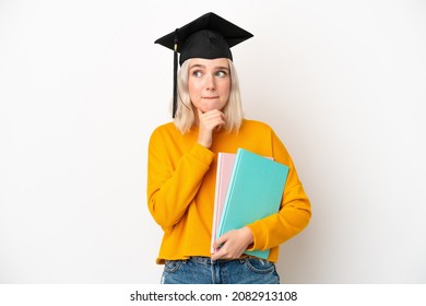 Young university caucasian woman graduate isolated on white background having doubts and thinking