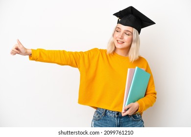 Young university caucasian woman graduate isolated on white background giving a thumbs up gesture