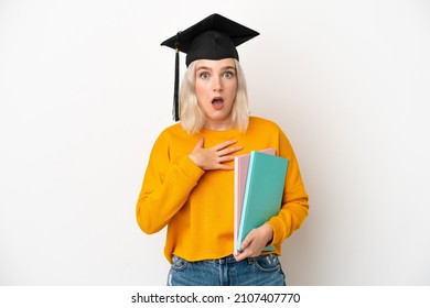 Young university caucasian woman graduate isolated on white background surprised and shocked while looking right