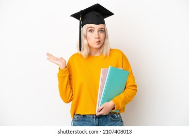 Young university caucasian woman graduate isolated on white background having doubts while raising hands