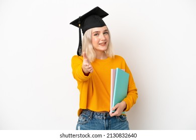 Young university caucasian woman graduate isolated on white background shaking hands for closing a good deal
