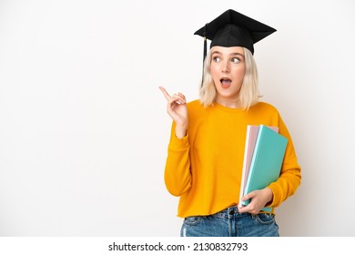 Young university caucasian woman graduate isolated on white background intending to realizes the solution while lifting a finger up