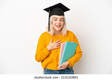 Young university caucasian woman graduate isolated on white background smiling a lot