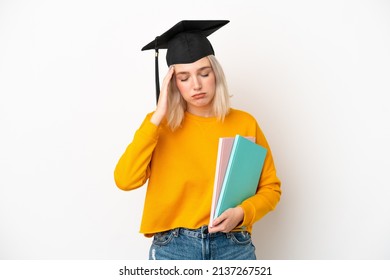 Young university caucasian woman graduate isolated on white background with headache