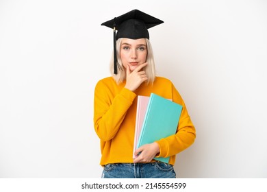 Young university caucasian woman graduate isolated on white background thinking