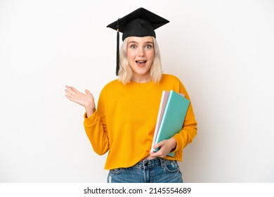 Young university caucasian woman graduate isolated on white background with shocked facial expression