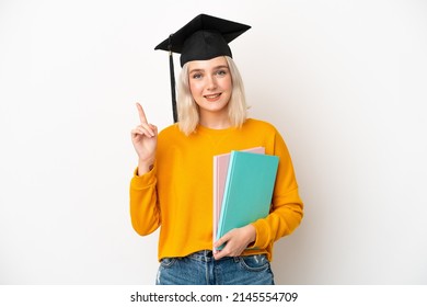 Young university caucasian woman graduate isolated on white background showing and lifting a finger in sign of the best