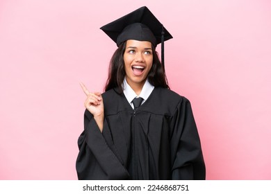 Young university Colombian woman graduate isolated on pink background thinking an idea pointing the finger up - Powered by Shutterstock