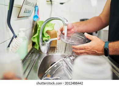 Young Unrecognizable Man Washing Dishes. Everyday Chores