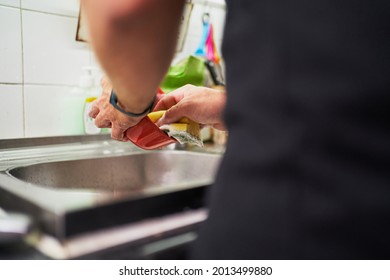 Young Unrecognizable Man Washing Dishes. Everyday Chores