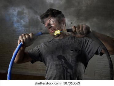 Young Untrained Man Joining Electrical Cable Suffering Domestic Accident With Dirty Burnt Face In Funny Shock Expression Screaming Crazy In Electricity DIY Repairs Danger Concept