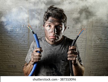 Young Untrained Man Joining Electrical Cable Suffering Domestic Accident With Dirty Burnt Face In Funny Shock Expression Screaming Crazy In Electricity DIY Repairs Danger Concept