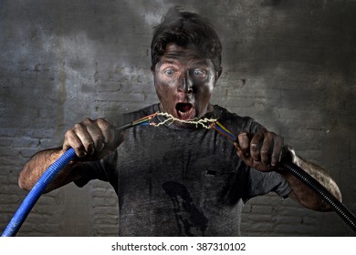 Young Untrained Man Joining Electrical Cable Suffering Domestic Accident With Dirty Burnt Face In Funny Shock Expression Screaming Crazy In Electricity DIY Repairs Danger Concept