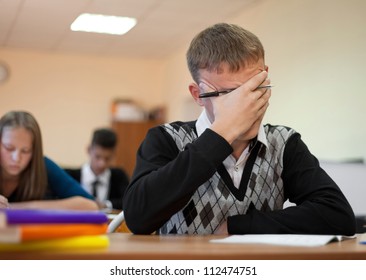 Young Upset Student Sits At The Table