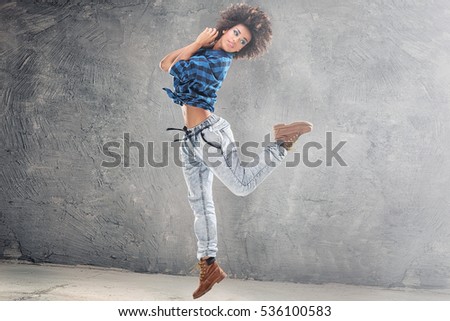 Similar – Young mixed woman with afro hair jumping outdoors.