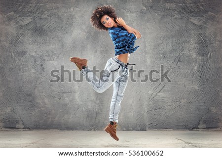 Similar – Young mixed woman with afro hair jumping outdoors.