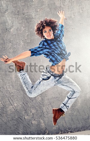 Similar – Young mixed woman with afro hair jumping outdoors.