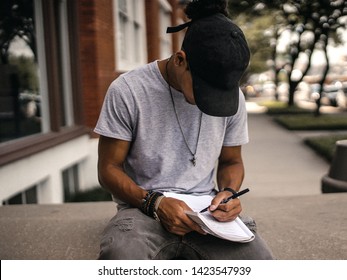 Young Urban Man Writing On City Stoop         