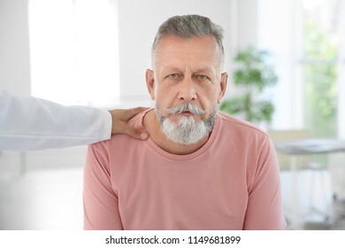 Young Urologist Comforting Upset Patient In Hospital