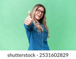 Young Uruguayan woman over isolated background with thumbs up because something good has happened