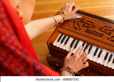 A Young Vaishnava Woman Is Playing Indian Traditional Musical Instruments For Kirtan Harmonium