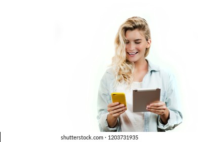 Young Very Beautiful Business Girl With A Phone And Ipad In Her Hands Smiles And Laughs At What She Saw In On A White Background