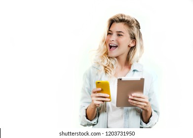 Young Very Beautiful Business Girl With A Phone And Ipad In Her Hands Smiles And Laughs At What She Saw In On A White Background