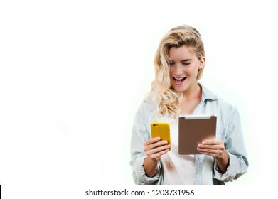 Young Very Beautiful Business Girl With A Phone And Ipad In Her Hands Smiles And Laughs At What She Saw In On A White Background