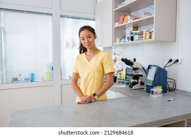 Young Vet Assistant Stands At Workplace In Animal Clinic