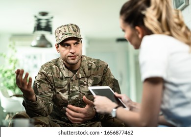 Young Veteran Talking To Healthcare Worker About His Mental Health Condition At Home. 