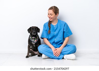 Young veterinarian woman with dog sitting on the floor isolated on white background with happy expression - Shutterstock ID 2154704297