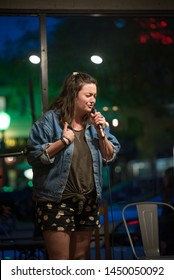 Young Vibrant Female Comedian Performs At A Local Coffee House Open Mic, Working To Perfect Her Act