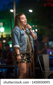 Young Vibrant Female Comedian Performs At A Local Coffee House Open Mic, Working To Perfect Her Act