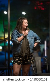 Young Vibrant Female Comedian Performs At A Local Coffee House Open Mic, Working To Perfect Her Act