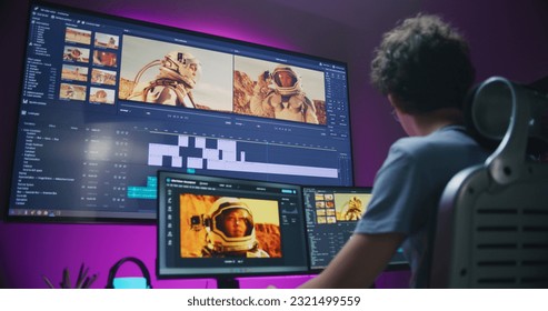 Young video maker edits movie about space mission, works at home office. Film footage and software interface with tools and sound tracks on computer and big digital screen. Concept of post production. - Shutterstock ID 2321499559