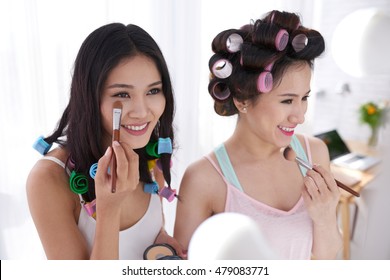 Young Vietnamese Girl Applying Concealer Under Eyes