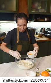 Young Vietnamese Woman Mixing  
Dough For A Cake