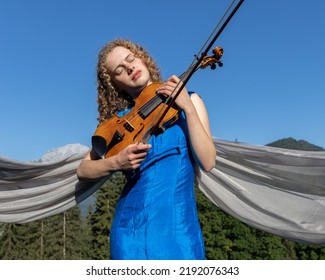 Young Violinist Playing Against The Sky