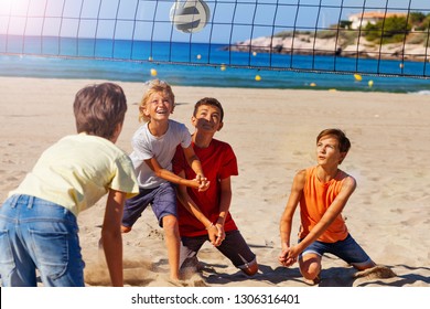 Young volleyball players in action on sandy beach