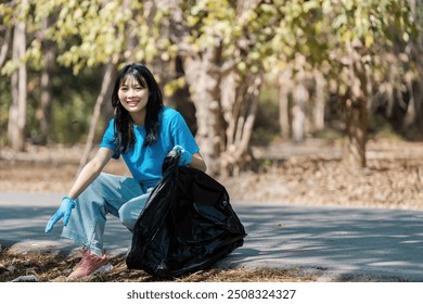 Young Volunteer Collecting Litter in Park, Environmental Cleanup Effort, Community Service, Eco-Friendly Initiative - Powered by Shutterstock